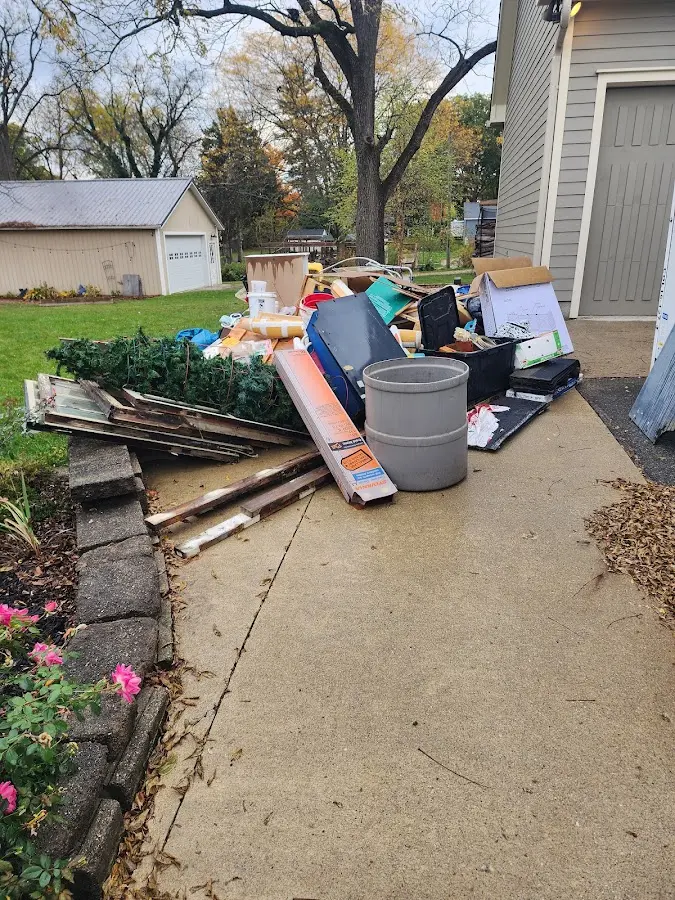Dumpster being loaded with debris for Estate Cleanout Dumpster Rental in Connersville